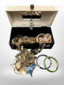 A jewellery box containing costume pearls, bangles, gilt chains,