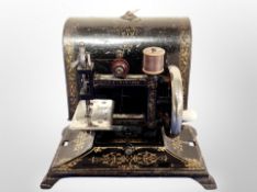 A 19th century Leigh and Crawford child's miniature sewing machine in lacquered box