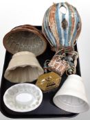 Four ceramic jelly moulds together with money box and hanging hot air balloon ornament
