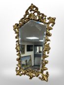 An early 20th century shaped gilt framed mirror 72 cm x 46 cm