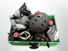 A box of roller blades, roller skates, sports clothing including helmets,