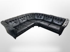 A late 20th century Danish L-shaped corner settee upholstered in black buttoned leather,