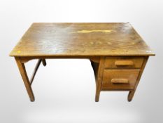 A 1930's oak single pedestal desk width 122 cm