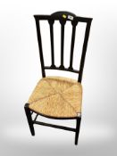 An ebonised cane seated chair