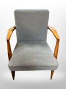 A late 20th century teak framed armchair in grey upholstery