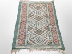 A Caucasian design rug on green ground 132 cm x 86 cm