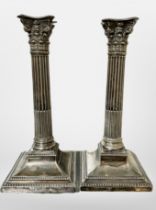 A pair of Walker & Hall silver-plated Corinthian column candlesticks,