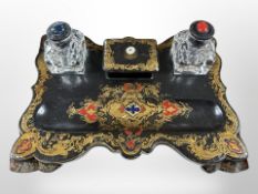 A Victorian papier mache desk standish with crystal inkwells,