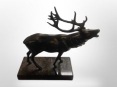 A patinated metal figure of a stag on marble plinth,