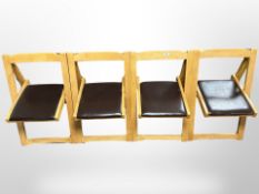 A set of four contemporary oak folding chairs