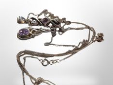 Two Art Nouveau style pendants on chains set with lavender coloured gemstones