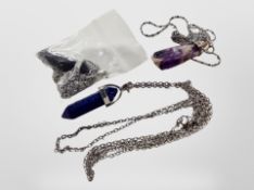 An amethyst pendant on fancy silver chain together with Obsidian and lapis lazuli crystal pendants
