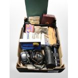 A box of vintage cameras and lenses, set of dominoes, colour postcards,