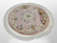 A Chinese pink circular rug,