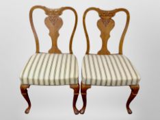 A pair of continental carved oak salon chairs