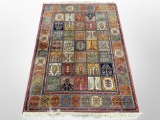 A machine-made rug of Persian Ghom design,