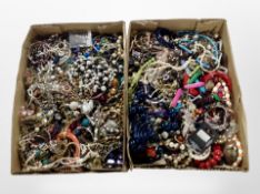 Two shallow boxes containing a large quantity of costume jewellery, bangles,
