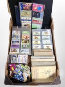 A box of cigarette cards and phone cards