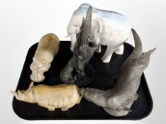 Two cast resin figures of otters, carved hardstone Rhino,