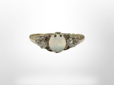 An antique yellow gold opal and two stone diamond ring, size S. CONDITION REPORT: 3.
