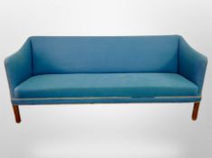 A mid 20th century Danish three seater settee in turquoise fabric,