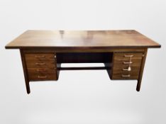 A 1970's Danish twin pedestal writing desk fitted with four filing drawers to each side,