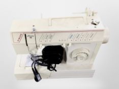 A Singer Melodie 40 electric sewing machine with lead and pedal