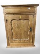 A 19th century pine single door cabinet,