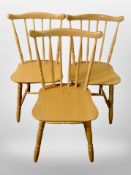 A set of three spindle backed dining chairs