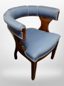 A Scandinavian horse-shoe shaped armchair in blue upholstery