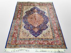 A machine made rug of Persian design 177 cm x 123 cm