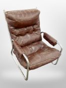 A 20th century Danish brown stitched leather and chrome armchair