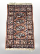 A machine-made Bokhara design rug,