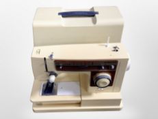 A Singer electric sewing machine model 6136 with lead and pedal