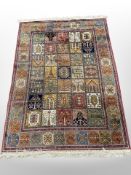 A machine-made rug of Persian Ghom design,