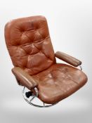 A 1970's Danish tan buttoned leather and chrome swivel armchair