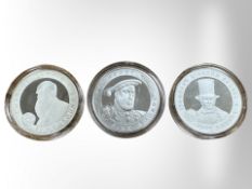 Three silver proof £5 coins depicting Charles Darwin, Henry VIII and Isambard Kingdom Brunel,