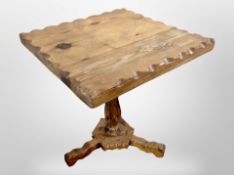 A rustic pine tripod table,