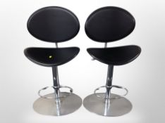 A pair of chrome and black vinyl bar stools