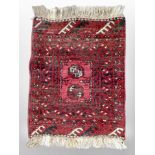 A small Afghan Bokhara rug 77 cm x 53 cm