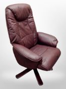 A Burgundy leather swivel armchair