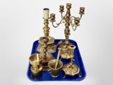 A brass five sconce table candelabrum, pair of candlesticks, pestle and mortar,