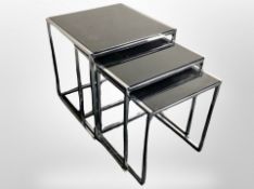 A late 20th century chrome and smoked glass nest of three tables,