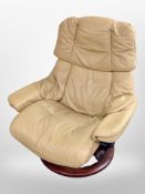A tan leather swivel armchair