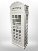 A white painted "telephone box" with wine storage interior,