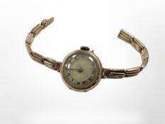 An antique 9ct yellow gold wrist watch with gold covered spring strap