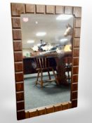 A 1970's simulated rosewood overmantel mirror 120 cm x 76 cm