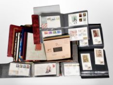 A box of several albums of first day covers,