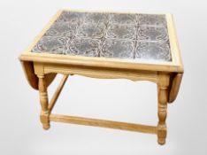 A Scandinavian blonde oak tile inset drop leaf coffee table,