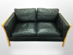 A contemporary Danish beech framed black leather two seater settee,